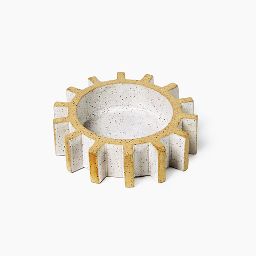 sculptural gear or cog tray on plain background