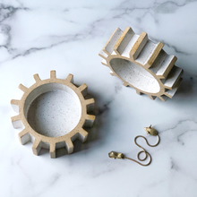 sculptural gear or cog tray on marble table